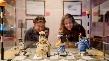 Visitors look at a Shaun the Sheep prop at Art of Aardman exhibition